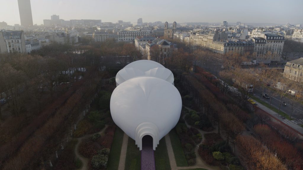 Drone view of monumental goddess figure installation behind Musée Rodin, Paris