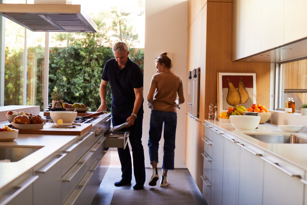 a white man and woman in a kitchen