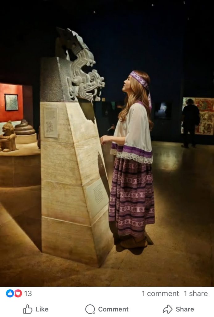an AI-generated image in which a woman is seen standing in profile in a museum setting contemplating an artifact on a pedestal