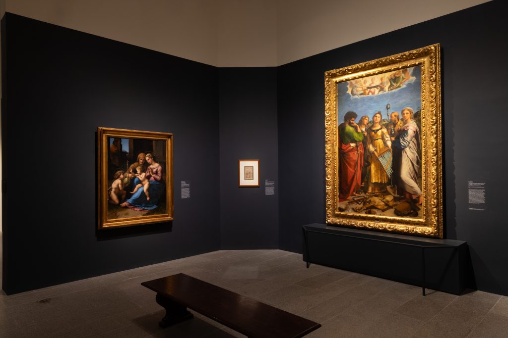 Gallery corner featuring Renaissance paintings in ornate gold frames, including a Madonna and child scene