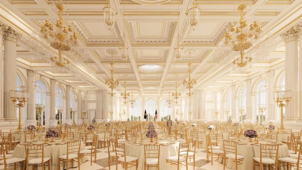A grand ballroom or banquet hall, lavishly decorated in white and gold, set up with numerous round tables for a large event.