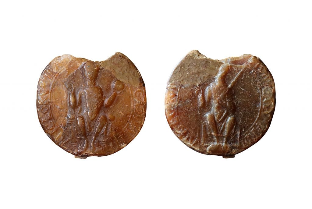 two sides of a wax seal on a white background