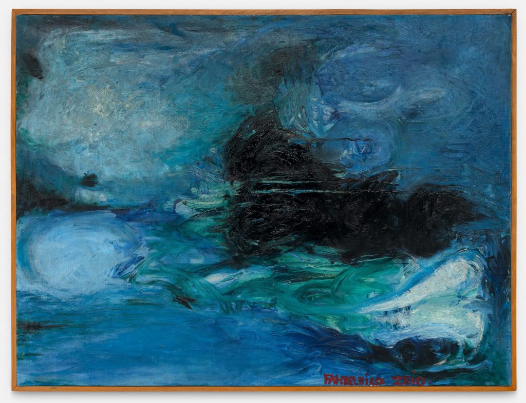 An expressive painting dominated by deep blues and turquoise tones, depicting a turbulent seascape. Swirling brushstrokes suggest churning water and wind, with a dark, boat-like form emerging near the center amid the waves. Lighter areas of white and pale blue evoke foam and spray, while the overall composition conveys movement and stormy intensity. The artist’s signature appears in red along the lower edge.