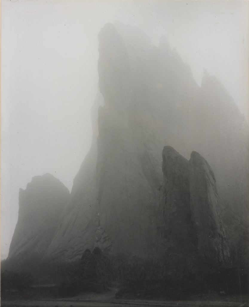 A hazy black and white photograph of a mountain face