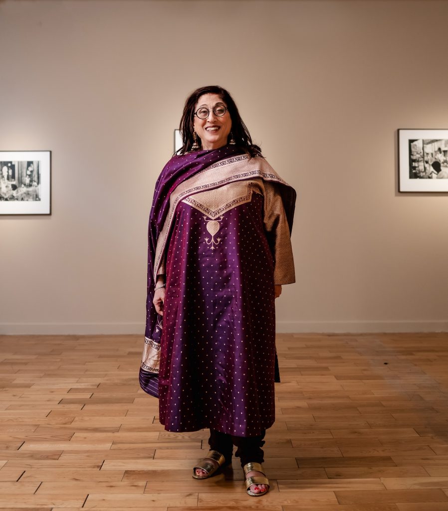 A woman, Kiran Nadar, poses for the camera
