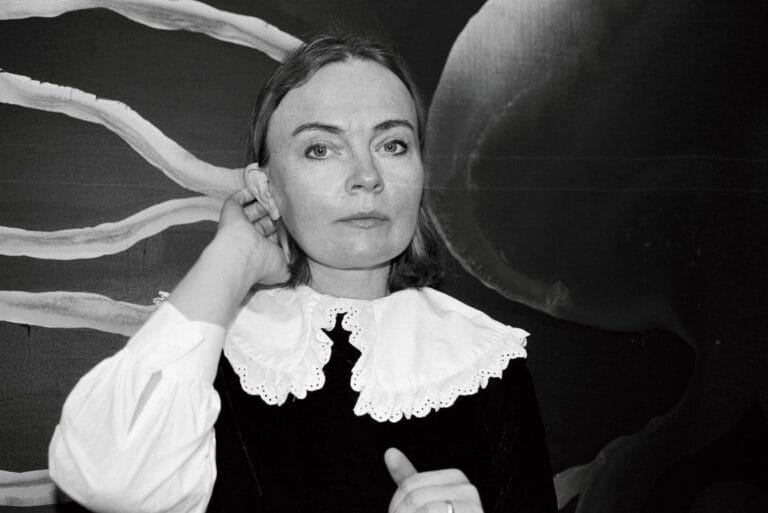 a black and white photograph of a woman with a large white lace collar.