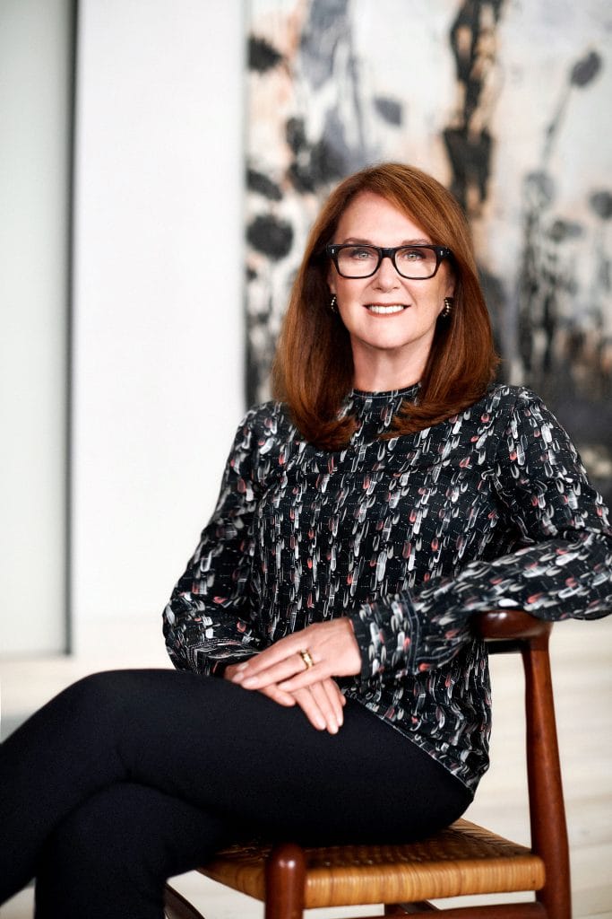 Portrait of Naomi Milgrom with Anselm Kiefer’s Merkaba (1997/2011) in the background.