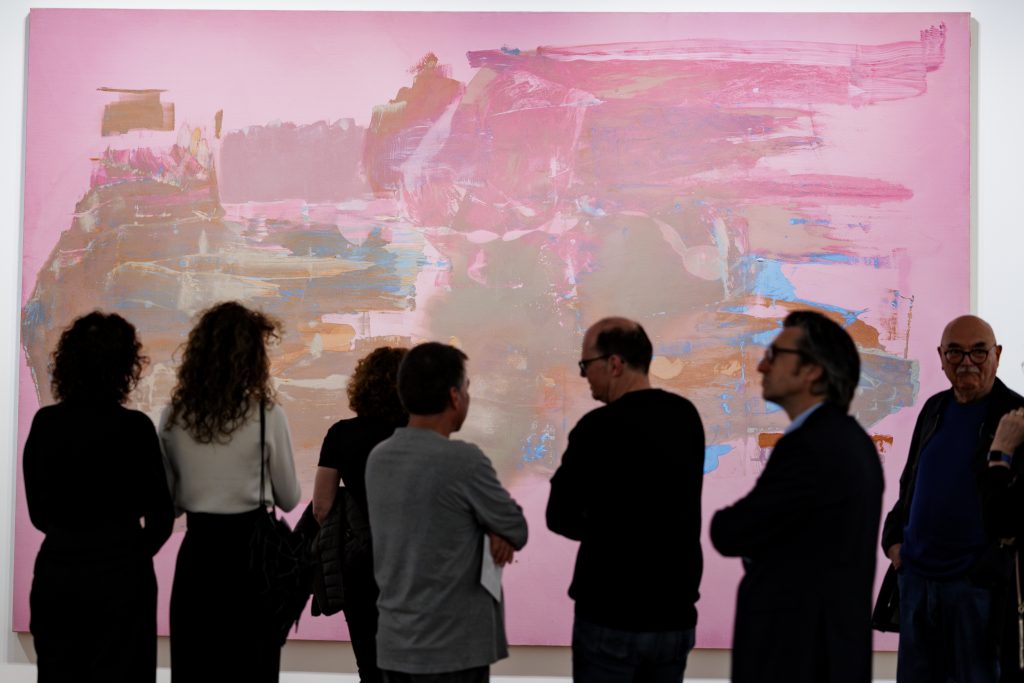 Visitors view Helen Frankenthaler's abstract pink painting at the "Move and Make" exhibition at the Museum Reinhard Ernst in Wiesbaden, Germany, 2025.