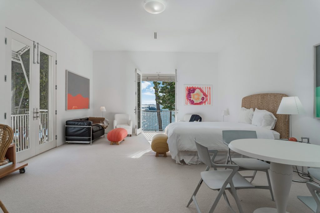 A luxurious bedroom with a view out over Biscayne Bay, in a mansion owned by Rosa de la Cruz