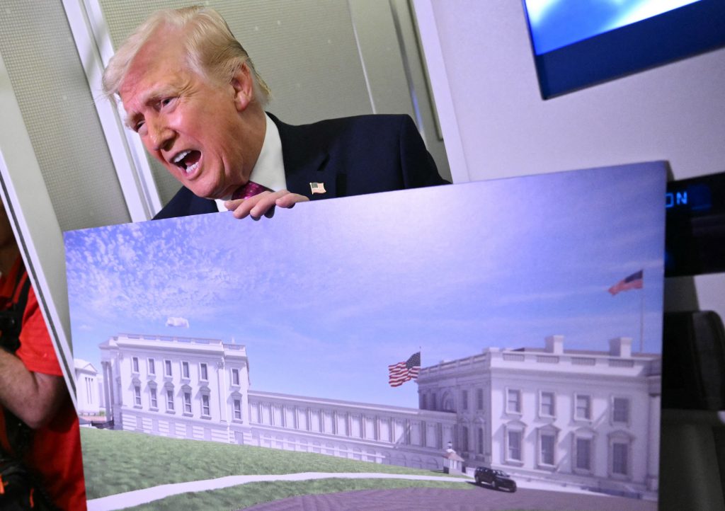 an image of Donald Trump holding a rendering of the East Wing proposed renovation