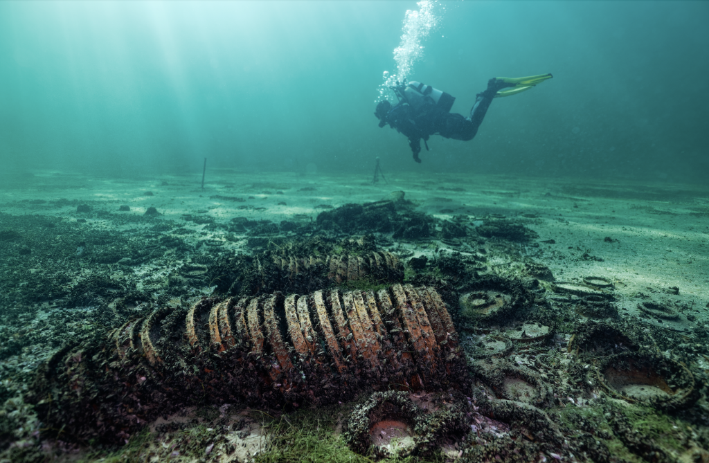 An underwater photograph of a diver exploring a Swiss shipwreck